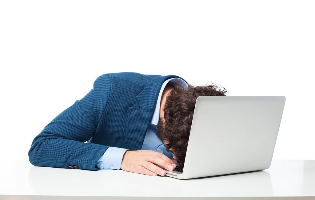 executive sleeping on laptop