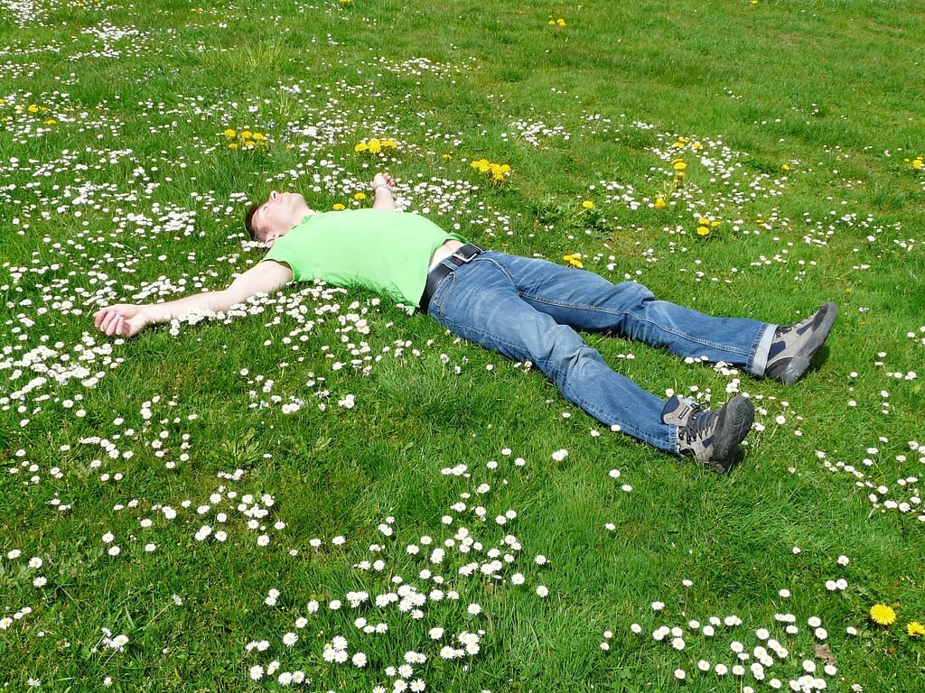 a man lying on the green grass