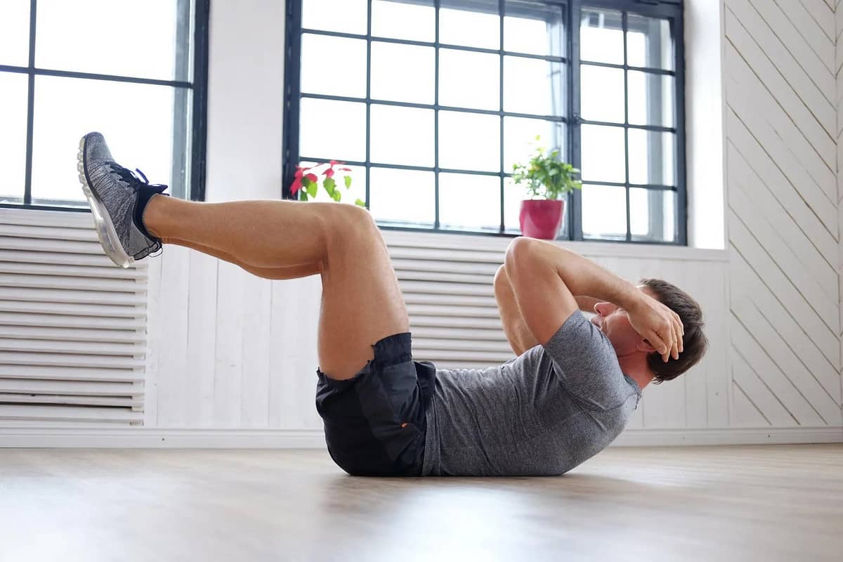 athletic middle age man doing stomach workouts home