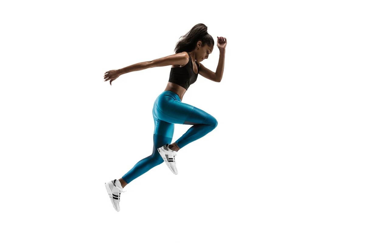 Free photo young african woman running isolated on white studio background.