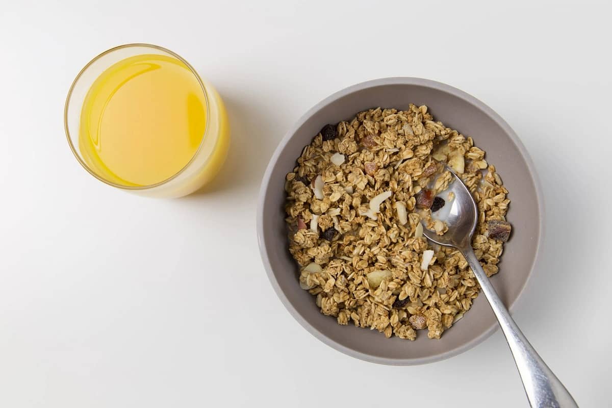 oats in bowl and a glass of juice on table