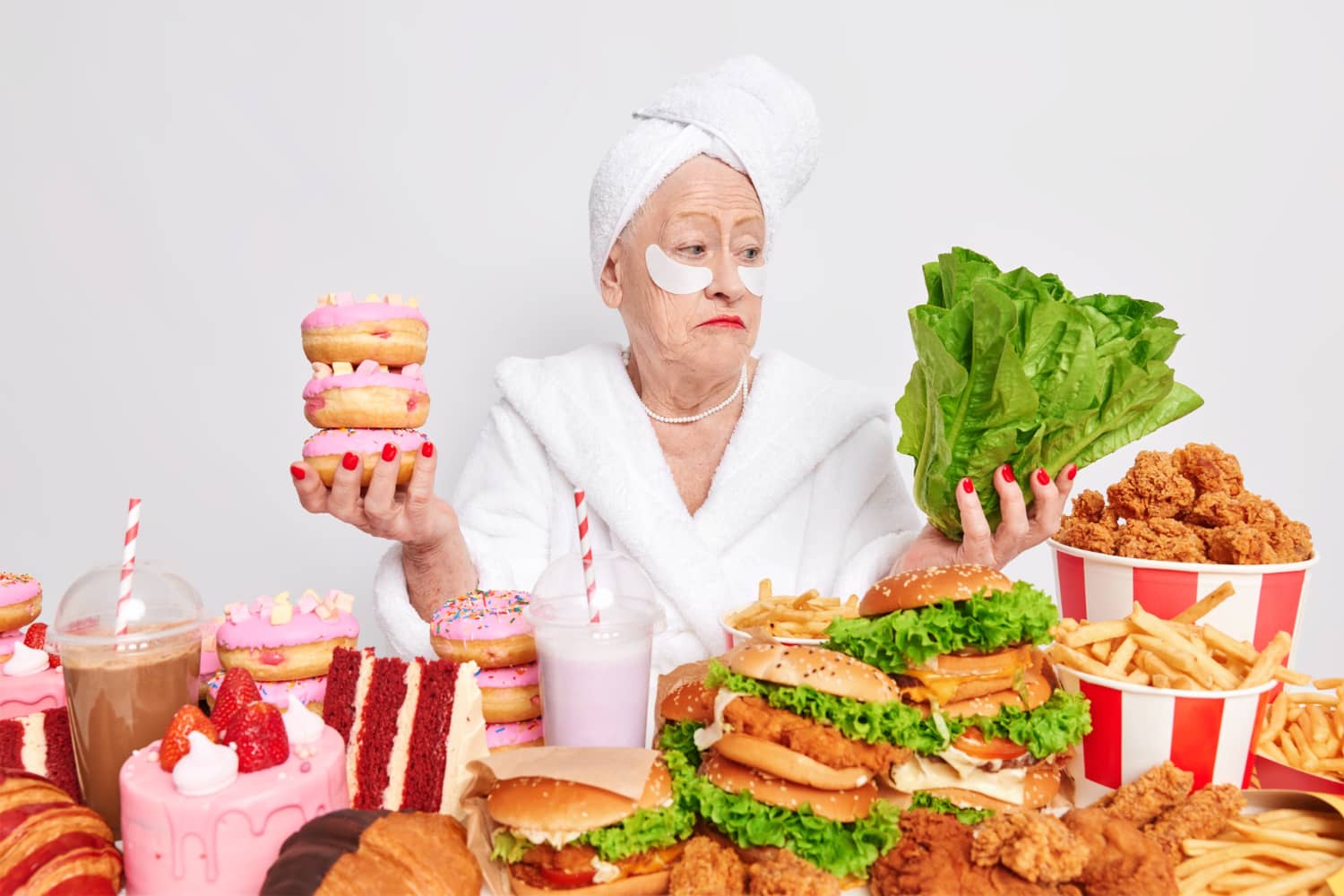 hesitant woman pensioner hesitates between healthy and unhealthy food