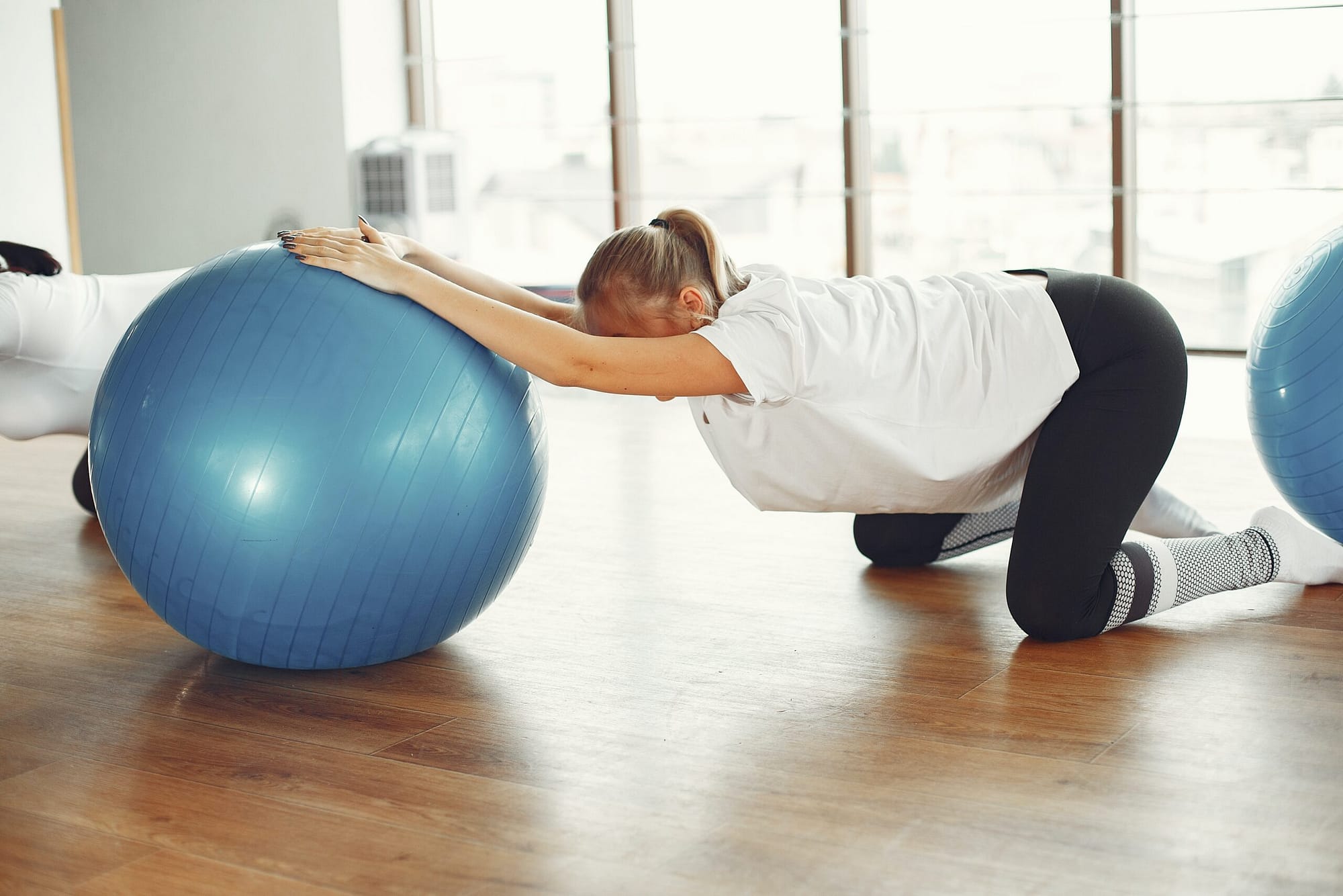A pregnant women doing exercise with ball - exercises to widen pelvis for birth