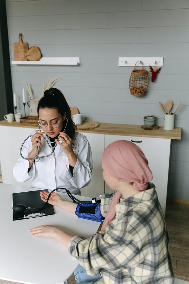a doctor checking blood pressure of a young girl