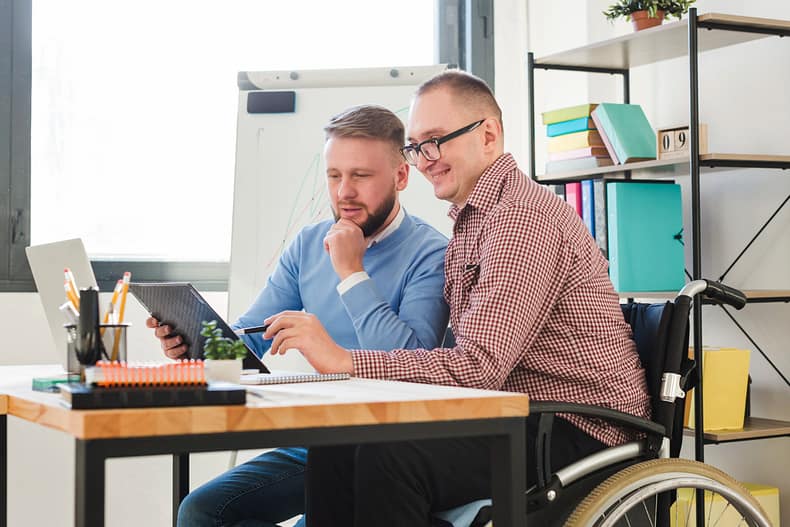 positive-disabled-worker-together-with-manager-office